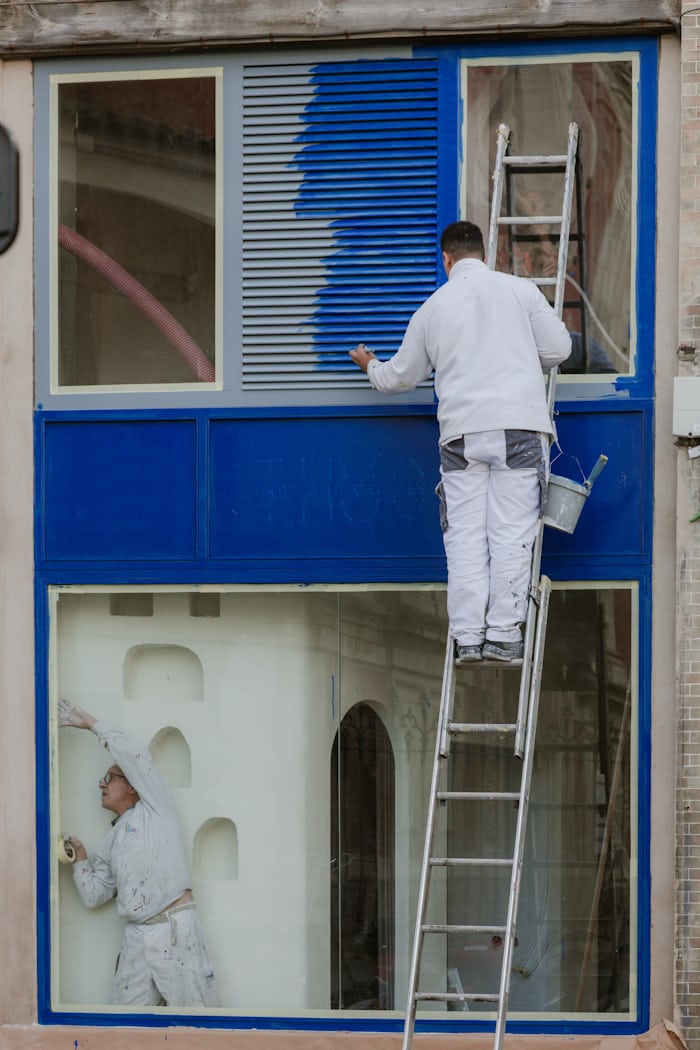Alpha Remodeling crew member painting interior trim